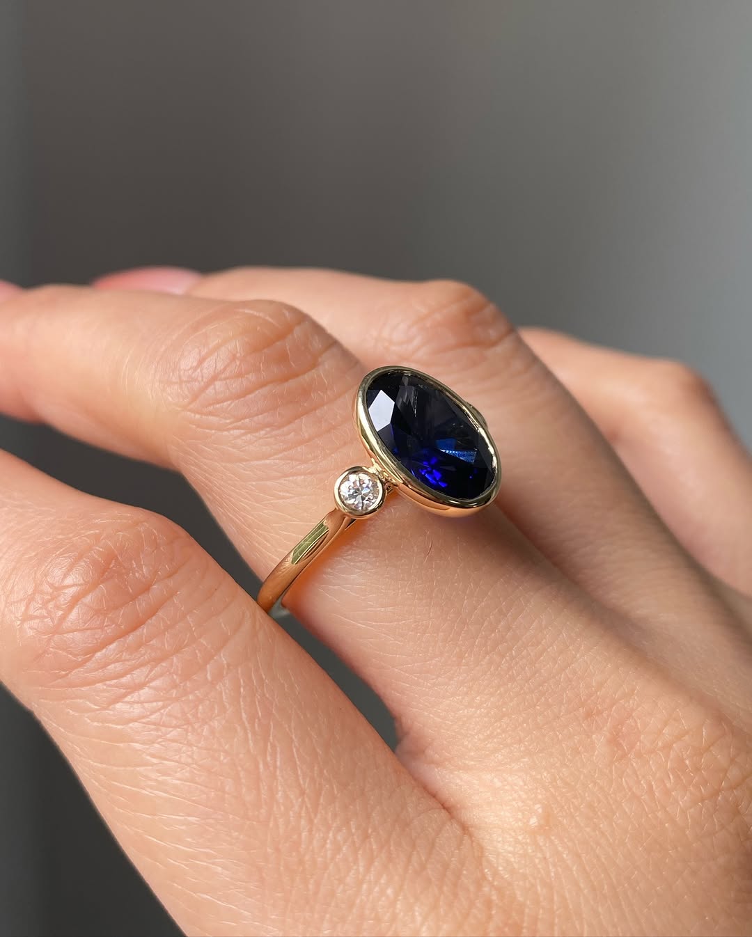 Blue Sapphire Oval Birthstone Bezel Setting Three Stone Engagement Ring